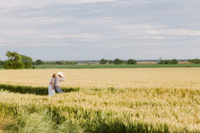 distance shot of Kat and Dillion walking into the wheat field 