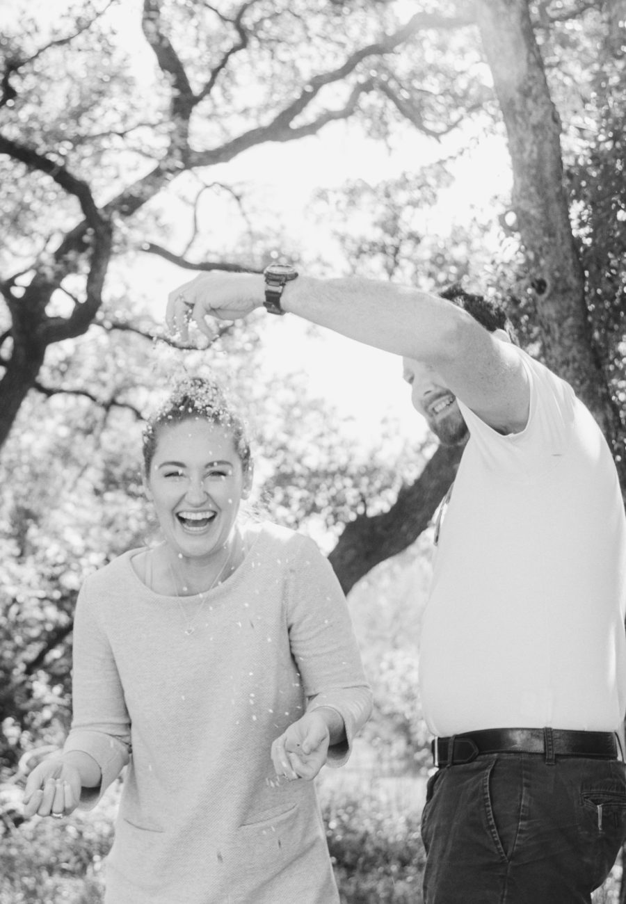 a black and white of Samantha and Eric smashing confetti eggs over each other's heads