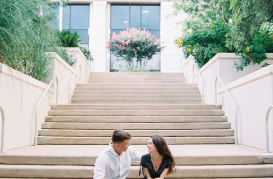 a couple sits on the stairs looking at each other during their engagement session, this image is bewing used a t the feature image of the Lady Bird Lake engagement shoot