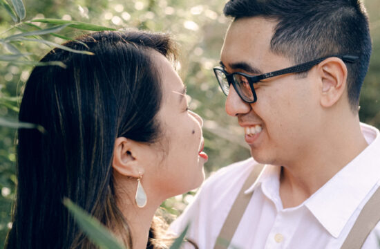 Tuyet and Jonathan stand in a bamboo forest looking at each other while Rae Allen Photography | surrounded by golden light during their engagment session at the Japanese Pagoda in Salado