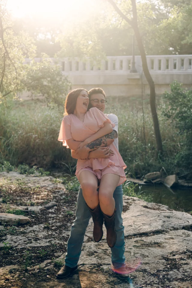 Matt grabs Macey from behind and picks her up while she laughs