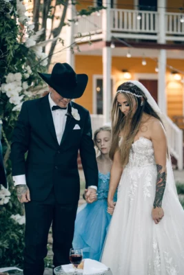 Paul and Brittany take communion with their daughter during thier wedding at Moon River Ranch | Rae Allen Photography