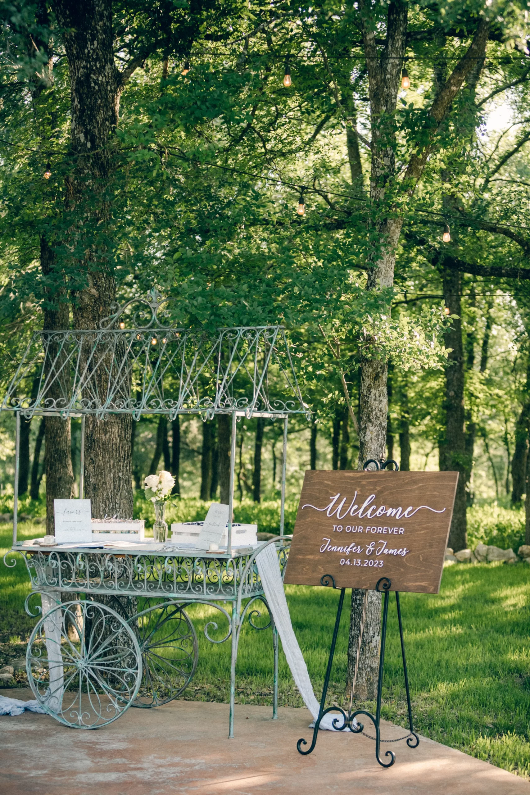 a metal cart holds a sign in book and a welcome sign for the maderakis wedding at silo and oak