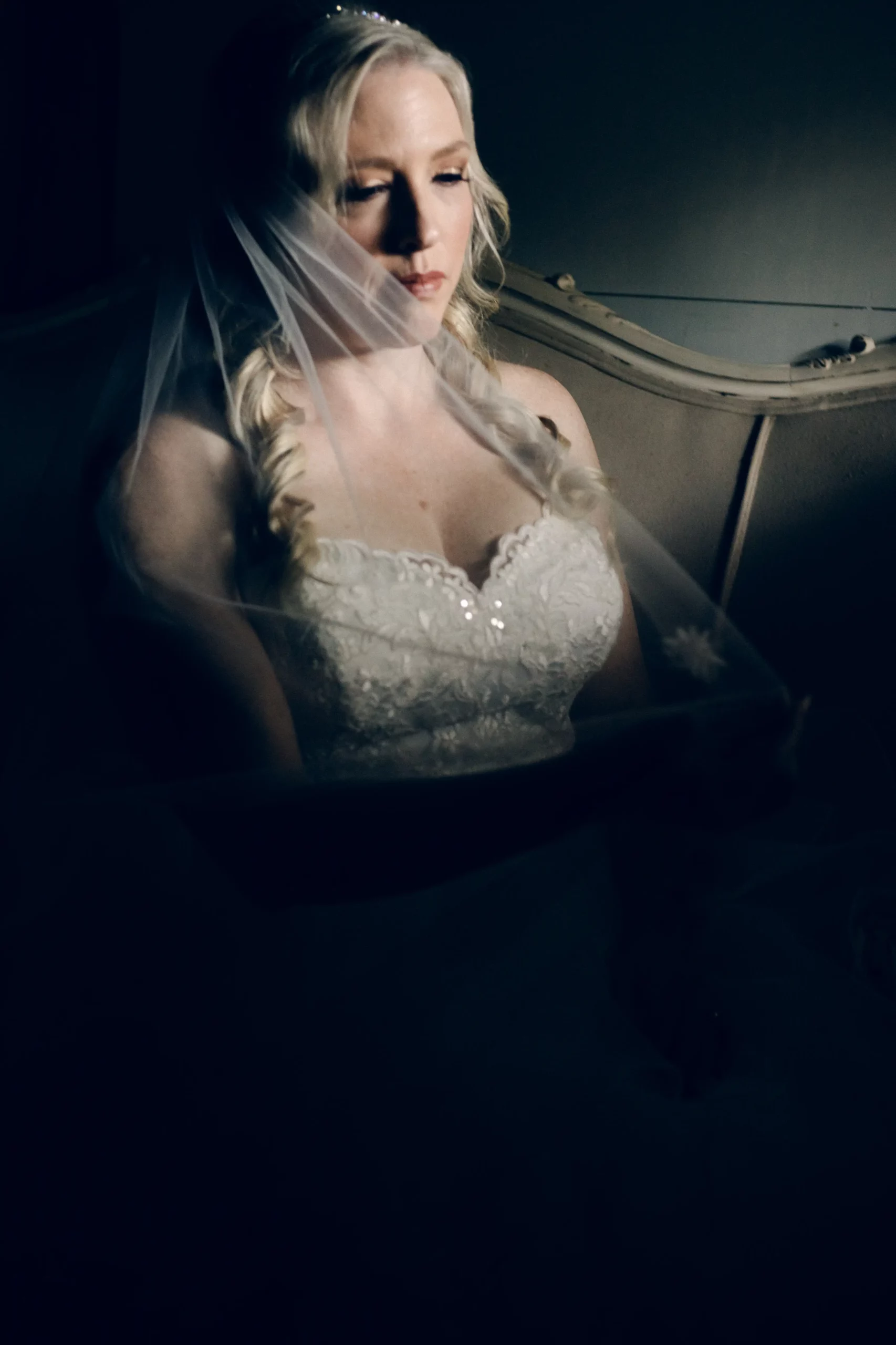The bride sits in the bridal suite on the couch for a bridal portrait on the day of her spring micro wedding