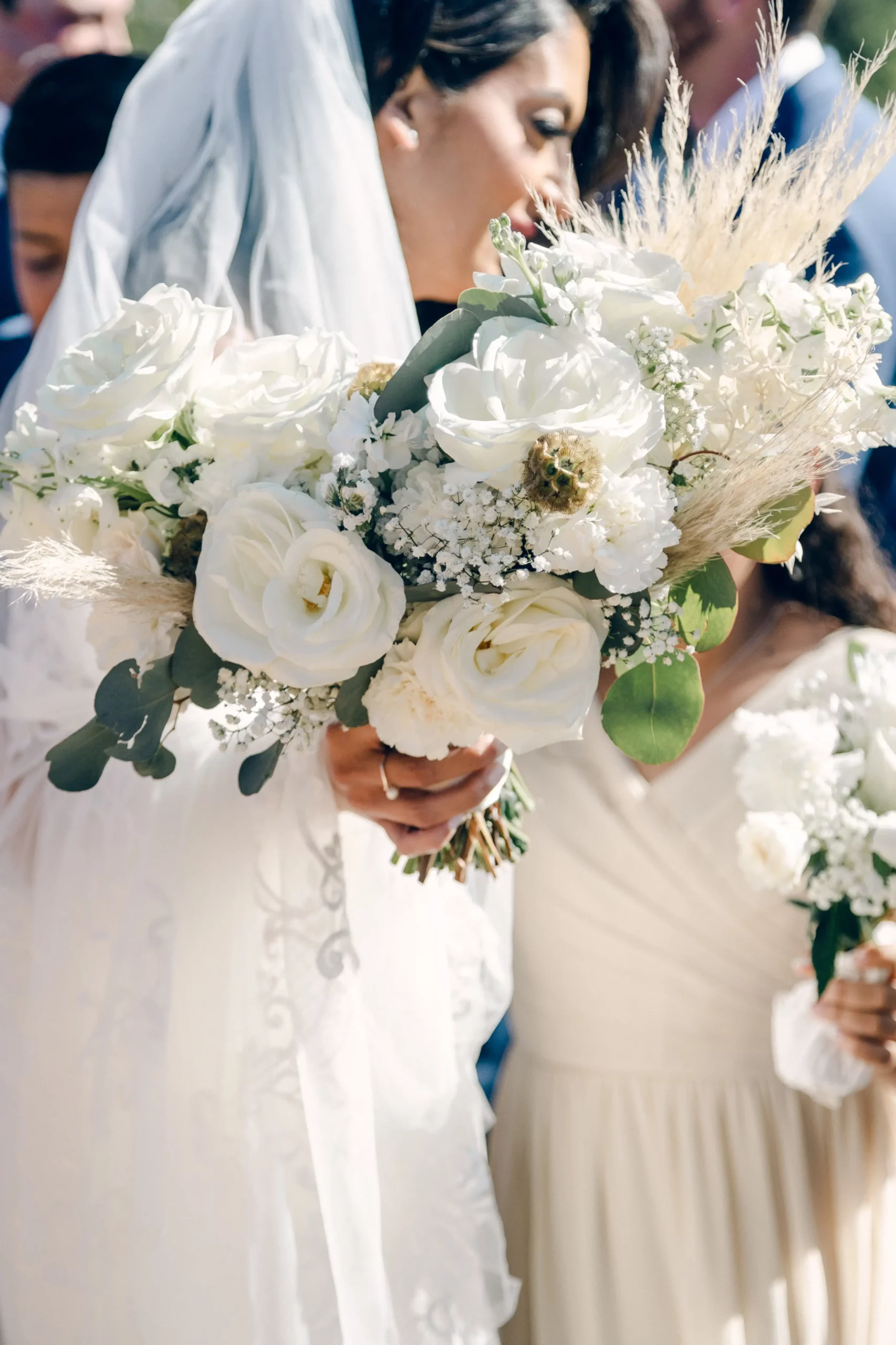 a close up of the bride's all white bouquet
