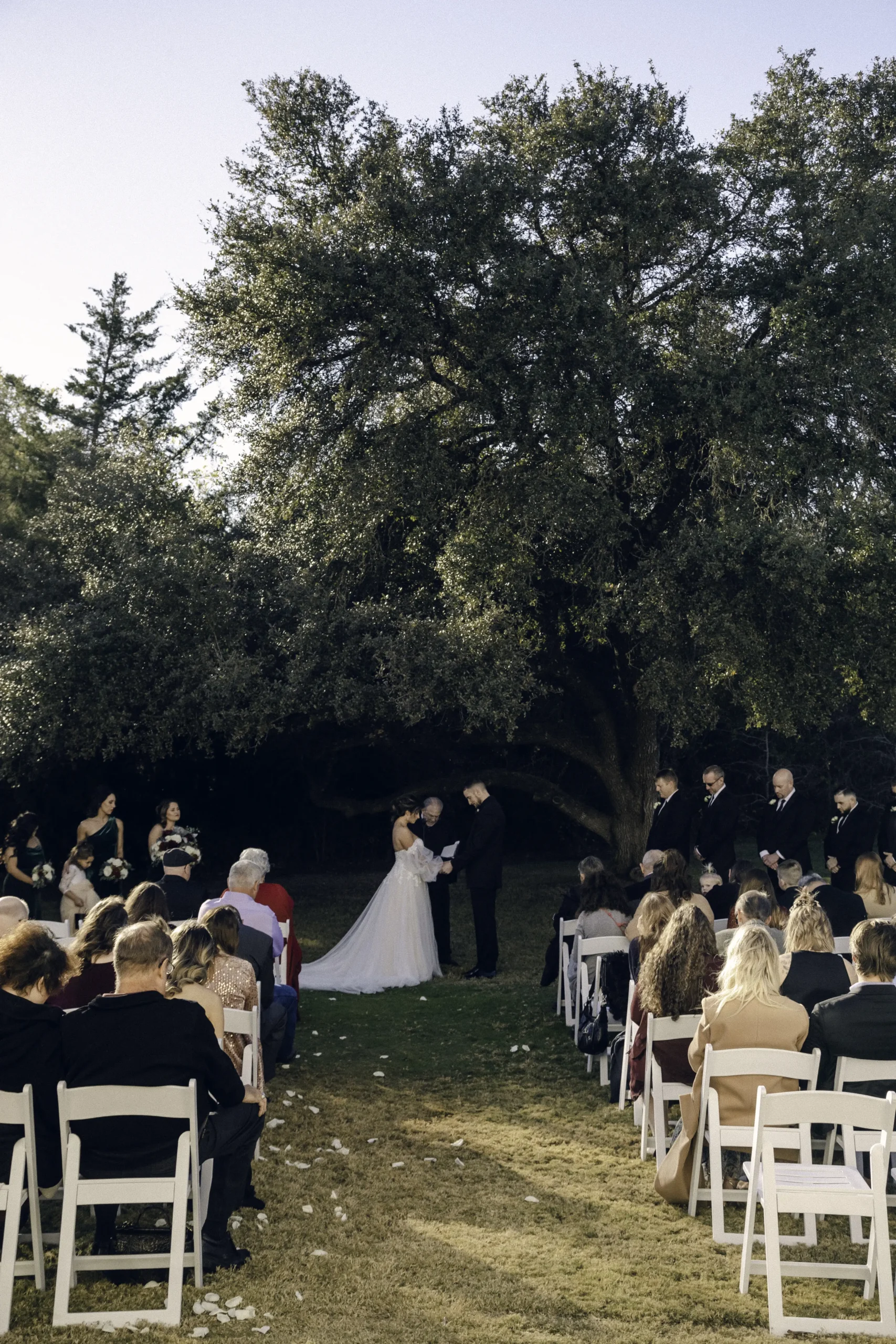 The groom and the bride bow theirs heads during their ceremony under the oak tree at Old Bethany | Rae Allen Portfolio